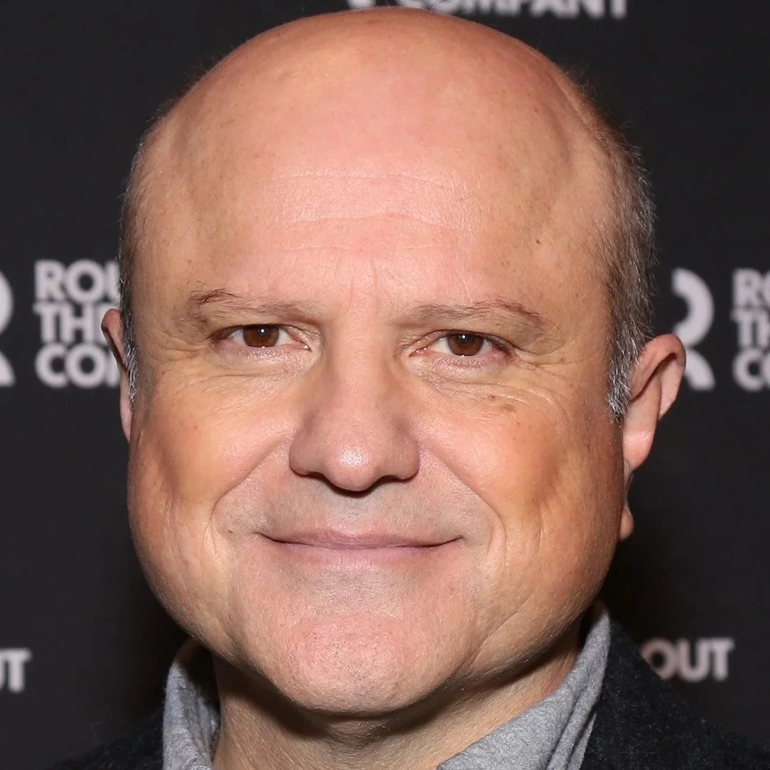 Close-up of Enrico Colantoni smiling at a red carpet event.