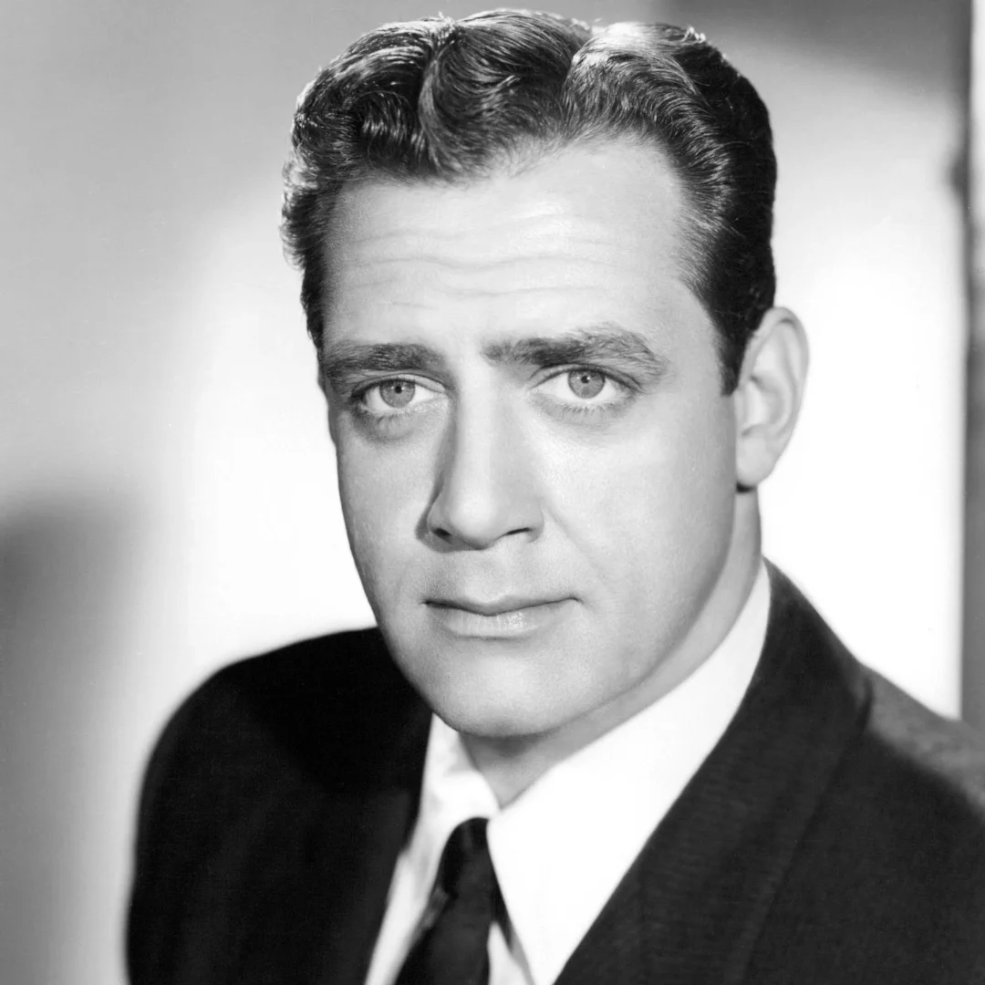 Black and white portrait of a man with short, neatly styled hair, wearing a suit and tie, with a serious expression and a plain background.