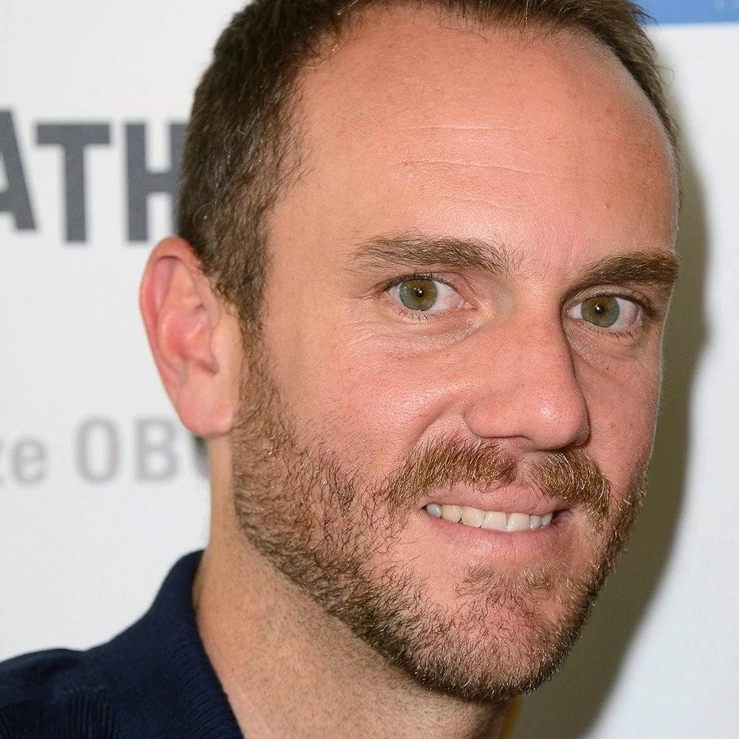 Charlie McDowell, American film director and screenwriter, smiling at an event