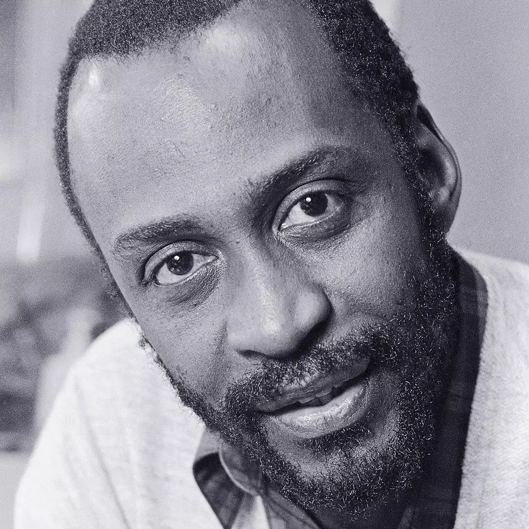 Tim Moore black and white close-up portrait with a beard and a warm smile