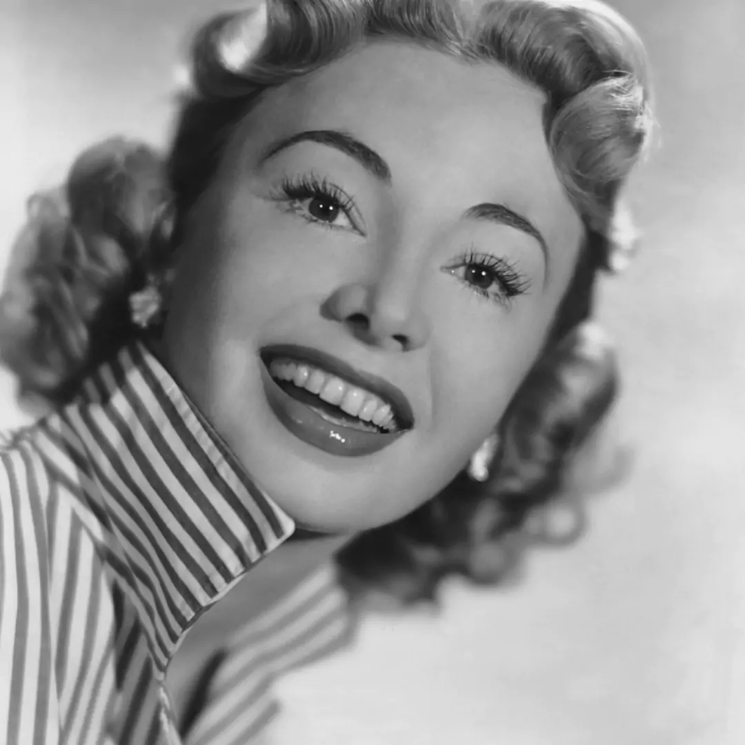 Audrey Meadows smiling in a classic black and white portrait, highlighting her iconic role in 'The Honeymooners' and her significant contribution to television history