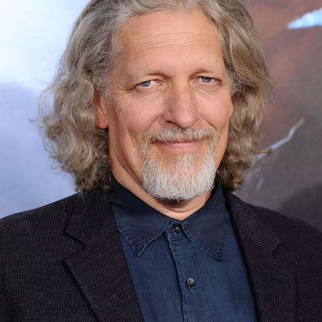 Clancy Brown smiling at a public event, highlighting his career as an actor