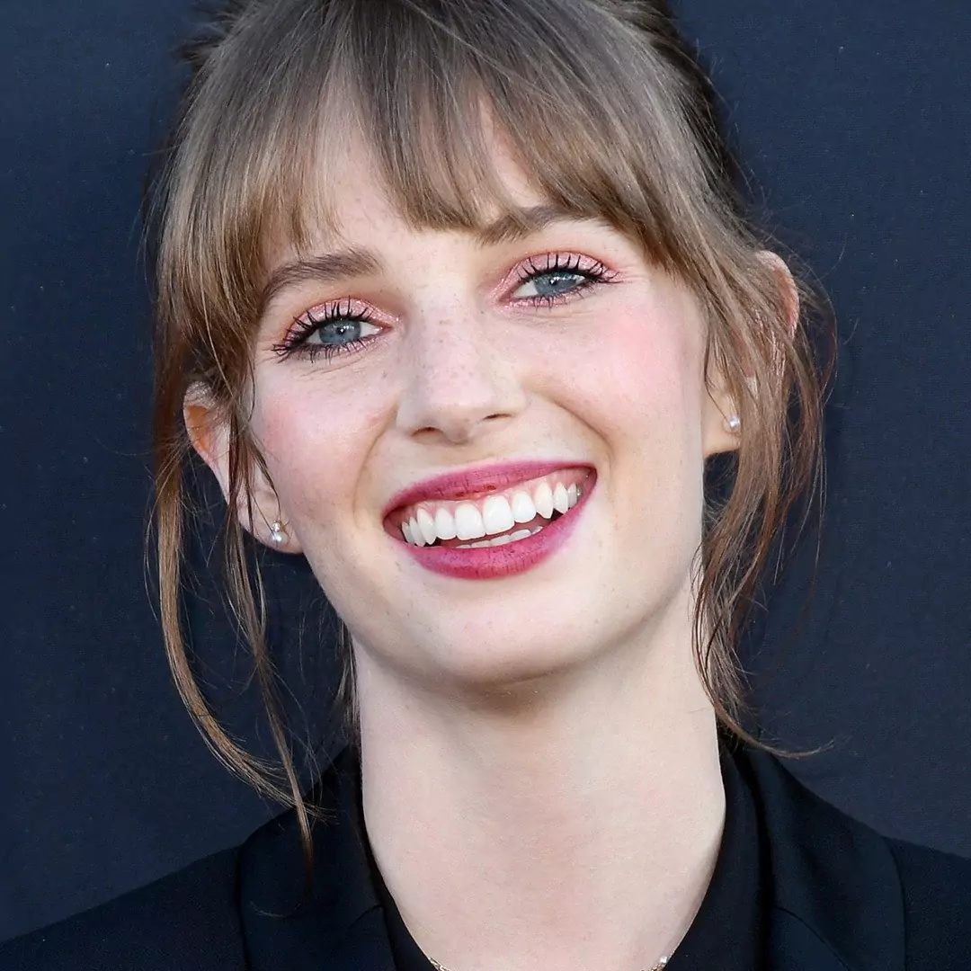 Maya Hawke smiling at a public event, highlighting her career as an actress and singer